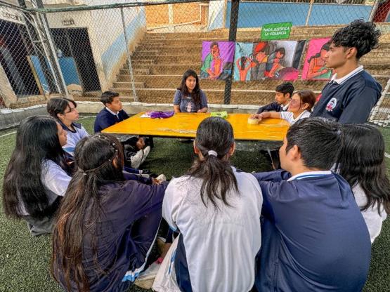 Students gather around table