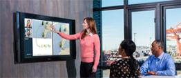 person in conference room touching tv screen