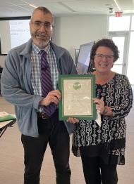 Athens HCOM Dean Tracy Shaub (right) presents CARE Award to Fabian Benencia