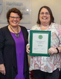 Athens HCOM Dean Tracy Shaub (left) presents CARE Award to Jill Montle