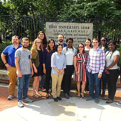 group of people in front of sign