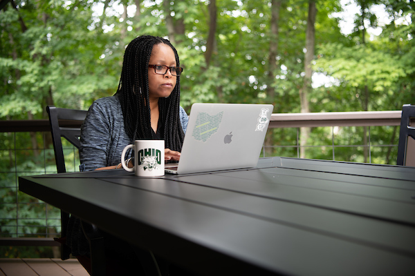 women sitting outside on computer