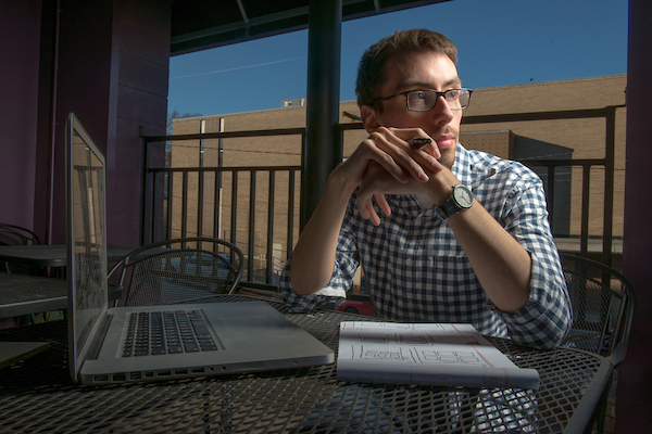 man sitting outside on computer