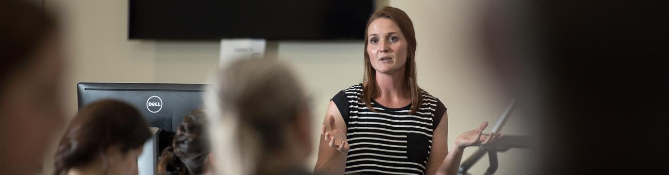 Woman speaking in front of crowd