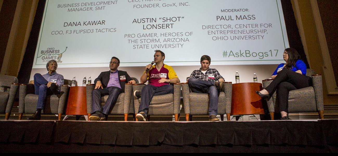 Panelists sit on stage during the Business of Games Summit