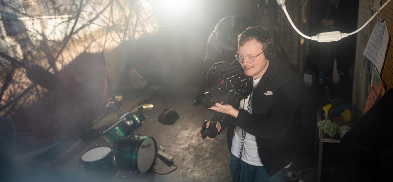 Student uses professional camera equipment to record video
