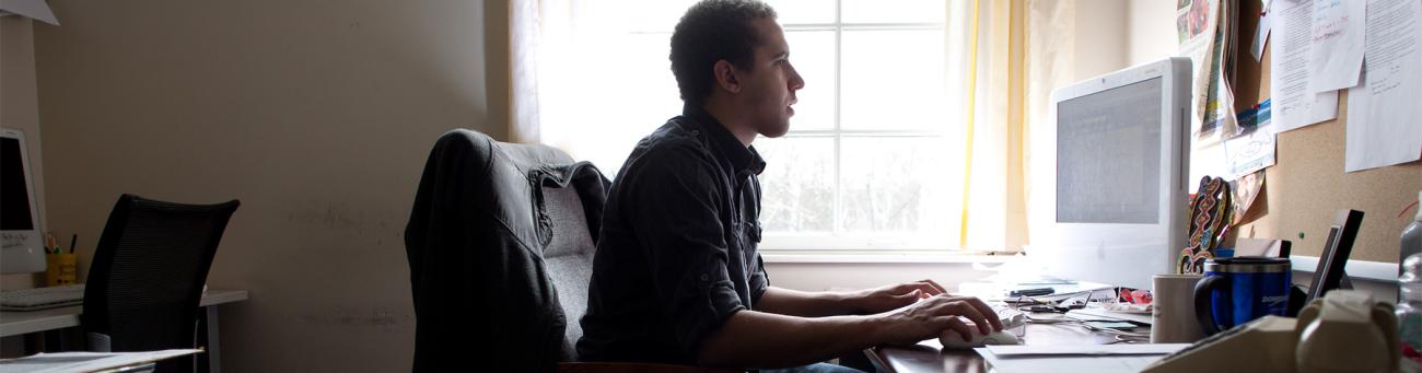 A student works at a computer.