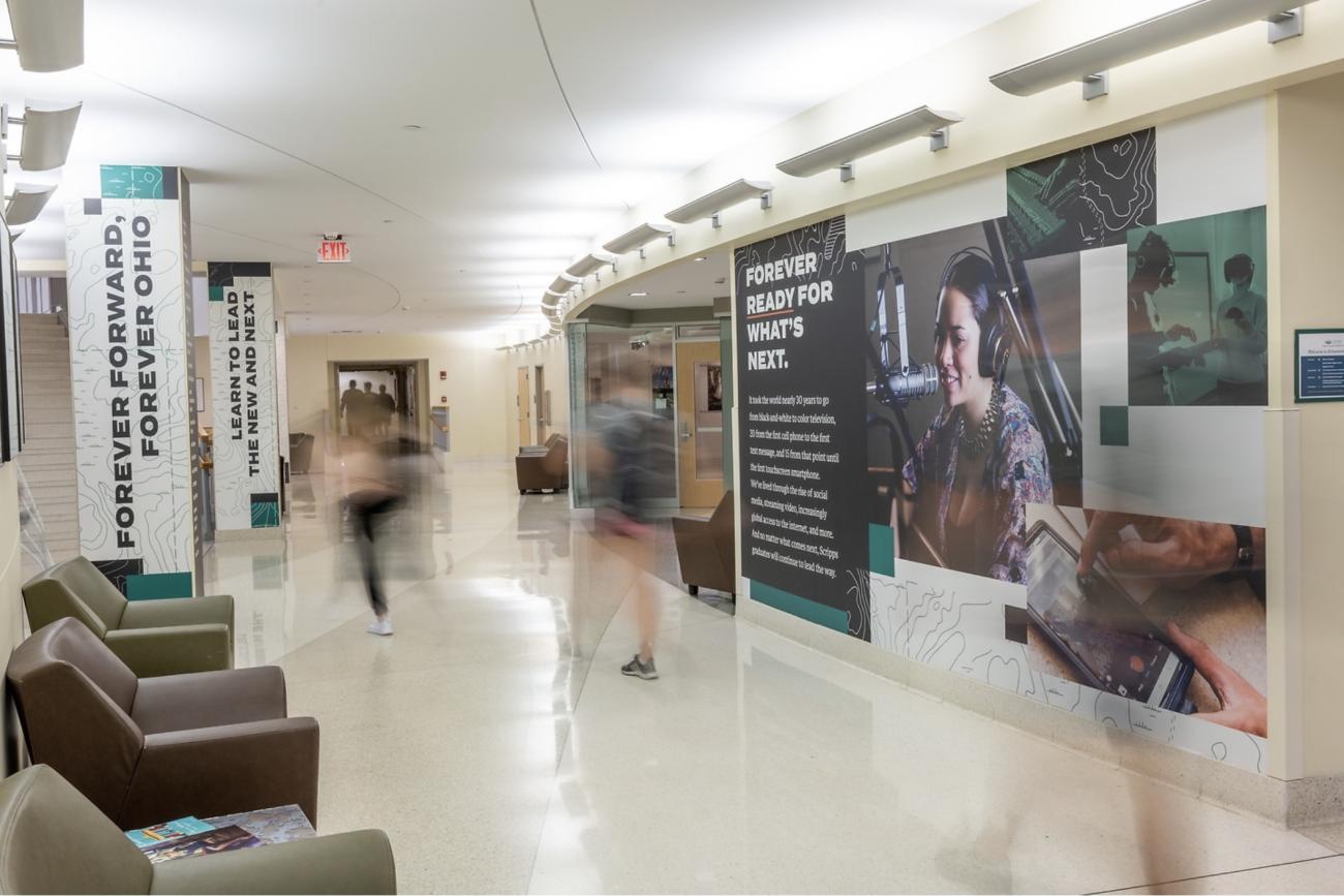 A long exposure image of students walking through the Schoonover Center.
