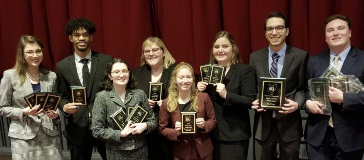group of people with awards
