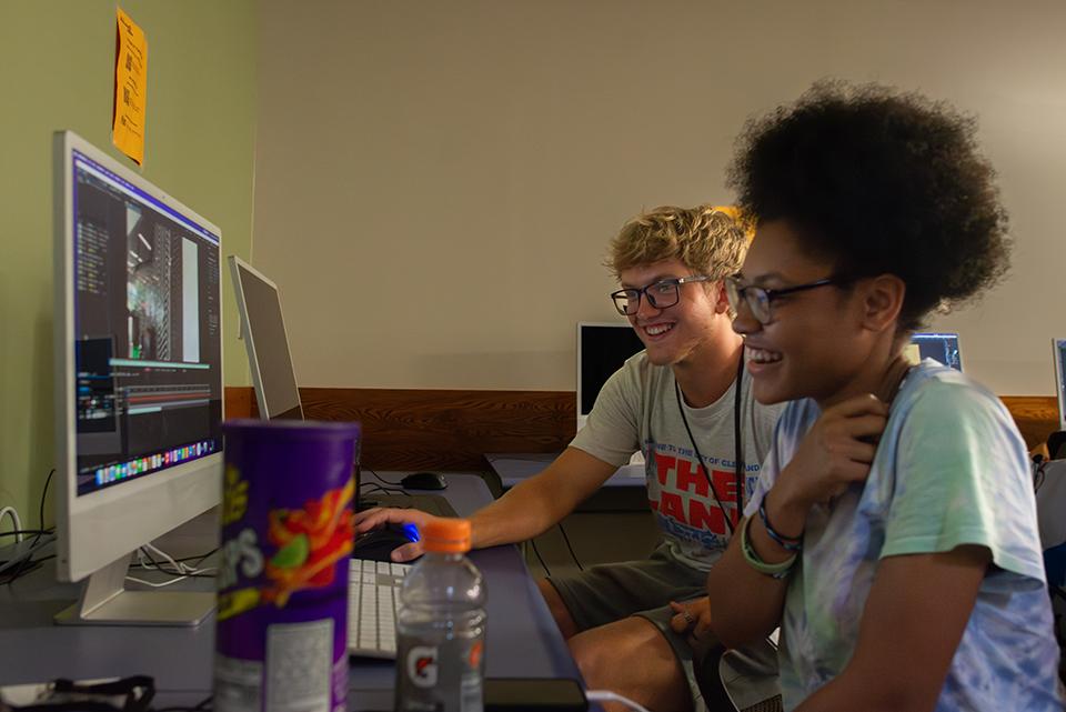 two students editing a video on a computer