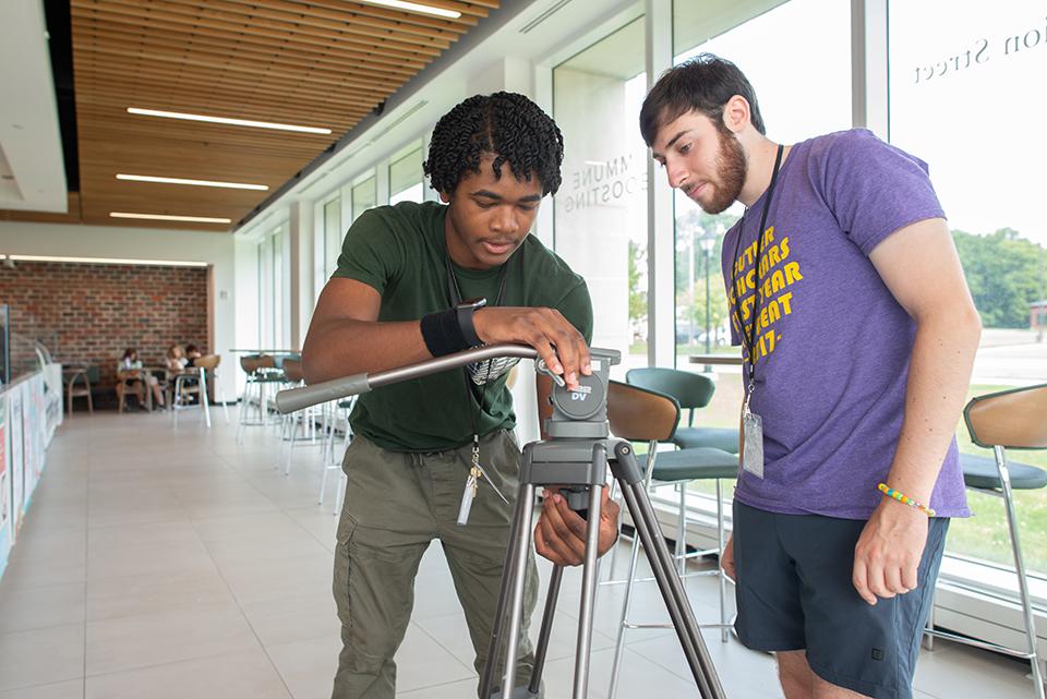 two students working with a camera