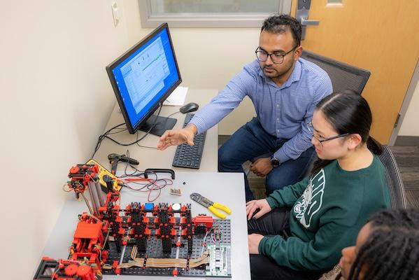 Students explore a setup for operational technology communications systems that are typically used in manufacturing facilities