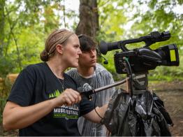 Andie Walla coaches a student on the camera during Nelsonville Music Festival.