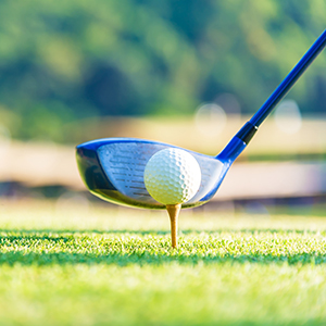 Driver ready to hit golf ball on a tee