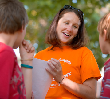 Instructor leading kid's class outside. 