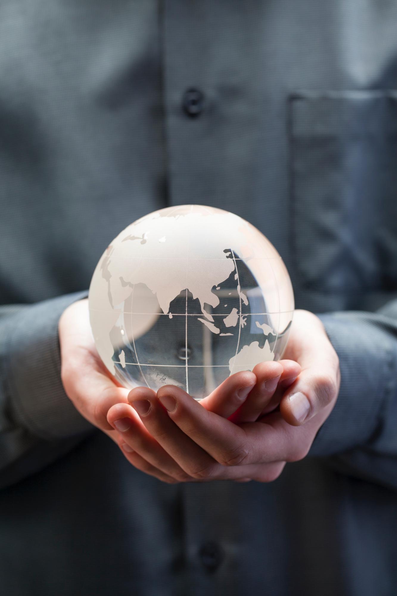 Glass globe being held in two hands