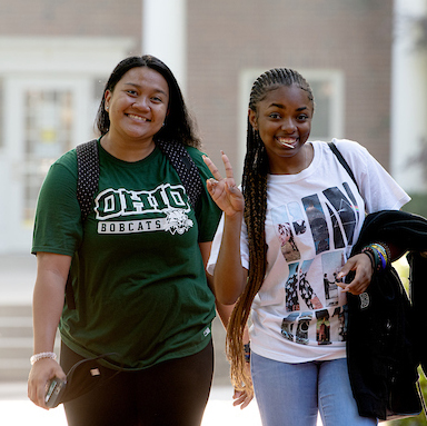 Two Ohio University students smile and pose