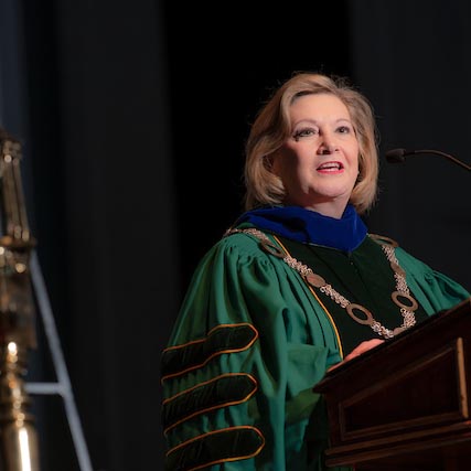President Lori Gonzalez speaks at a podium