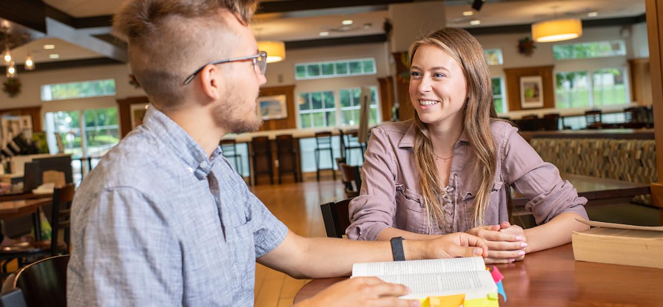Two people talking in a coffee shop