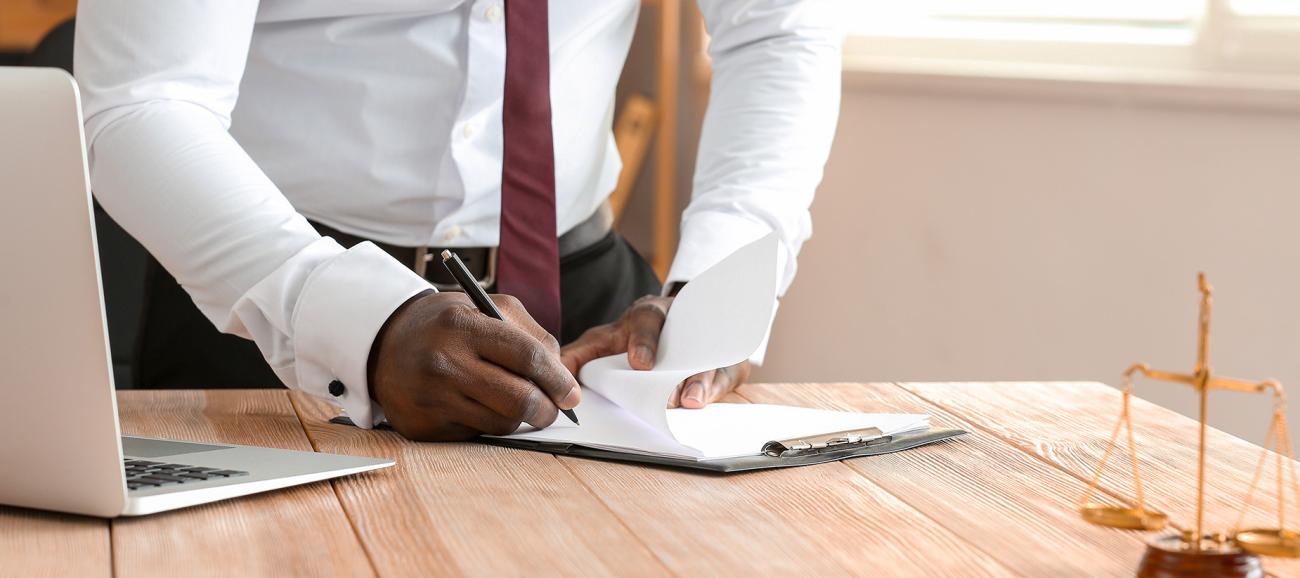 Business man writing something on a legal pad