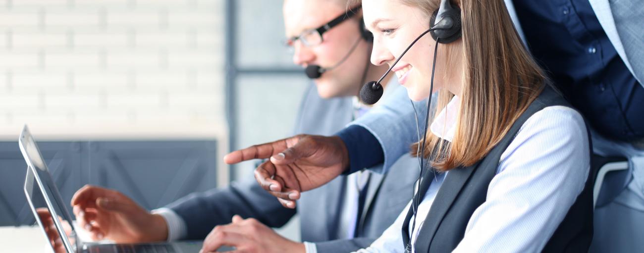 Business people with headsets on in a call center or something similar