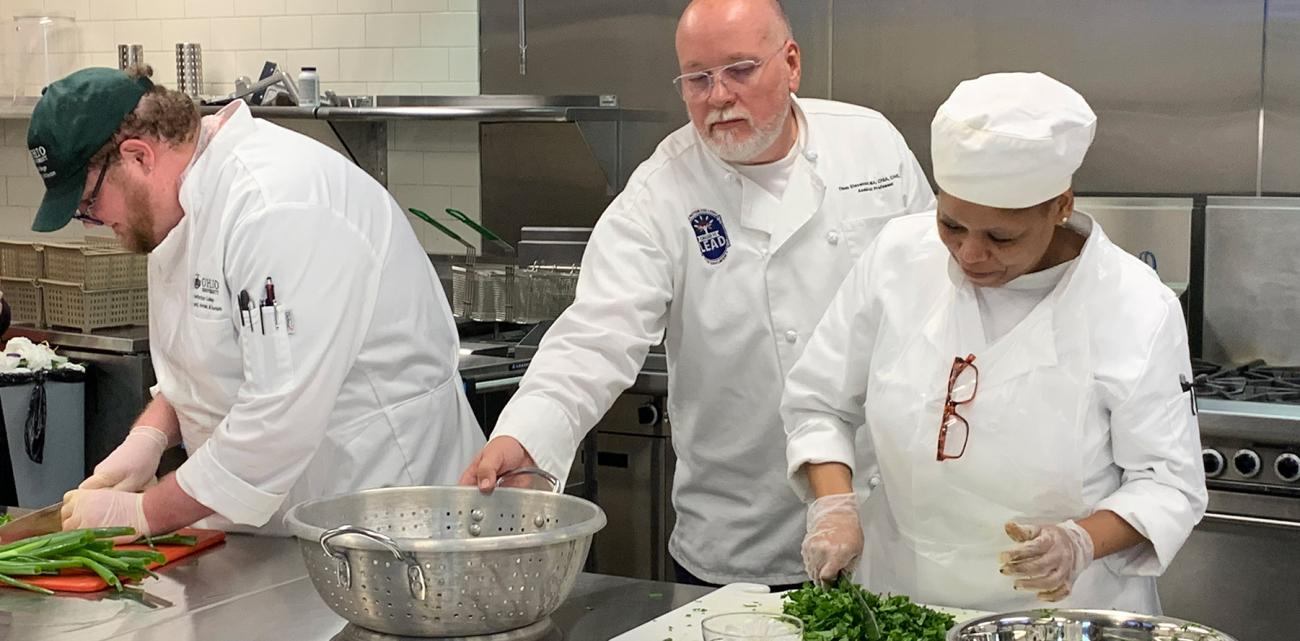 Culinary students work together while cooking