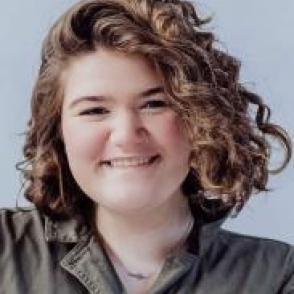 Emily Van Meter smiles at the camera wearing a pale green collared shirt.