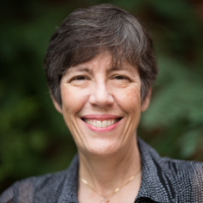 Dr. Jellison in a black collared shirt with white dots on it.