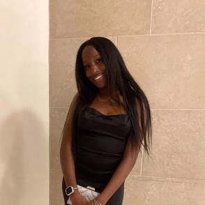 An image of Raziya Croom in a formal black dress.