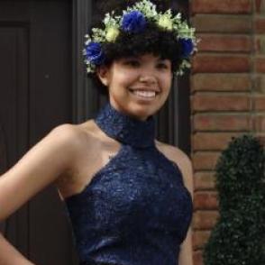 Sierra Bowersock in a blue halter dress wearing a blue and white flower crown.