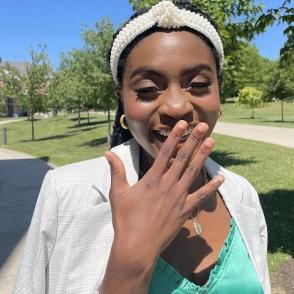 Christine Blay laughs and smiles at the camera.