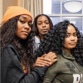 Three members of Ebony Minds pose together