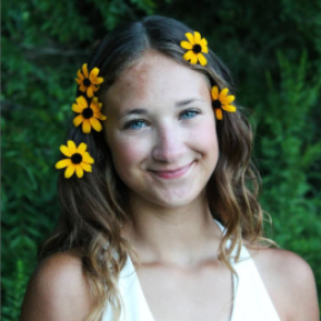 Portrait of a women with yellow flowers in her hair