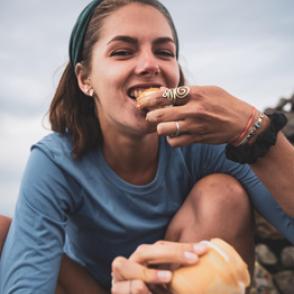 Ruby Williams smiles while eating a snack with peanut butter