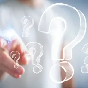 Image of finger pointing toward question marks