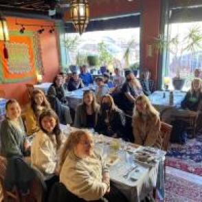 Students pose at a restaurant together