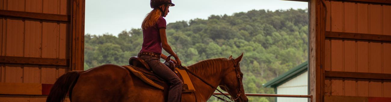 Student riding horse