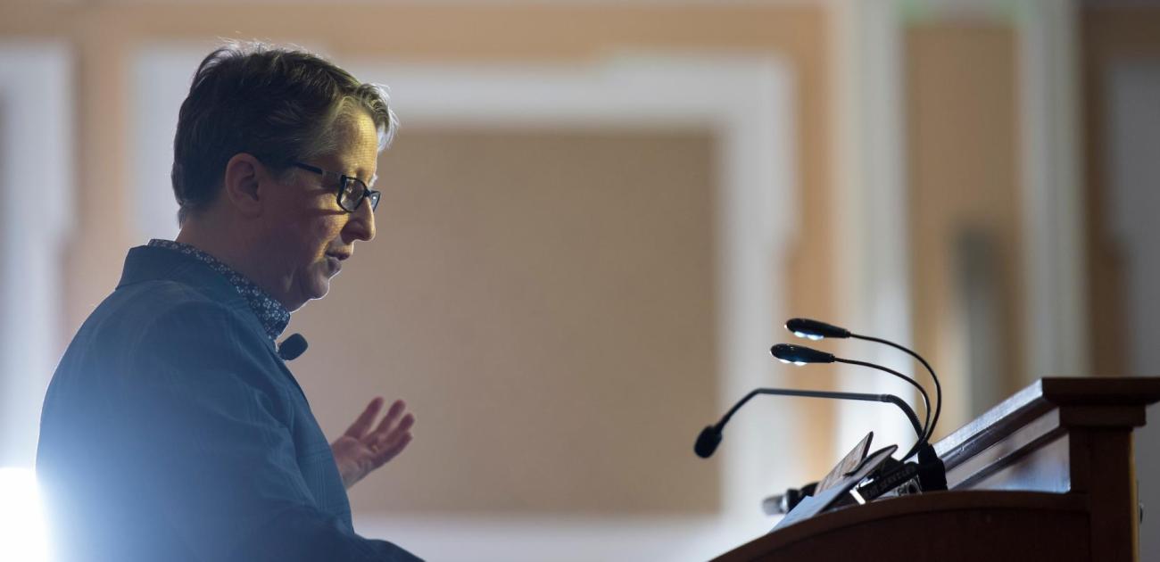 An instructor speaks at a lecturn