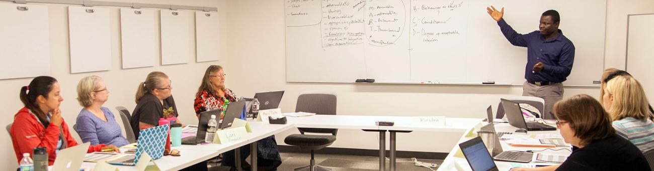An instructional designer explains teaching practices to faculty during a workshop