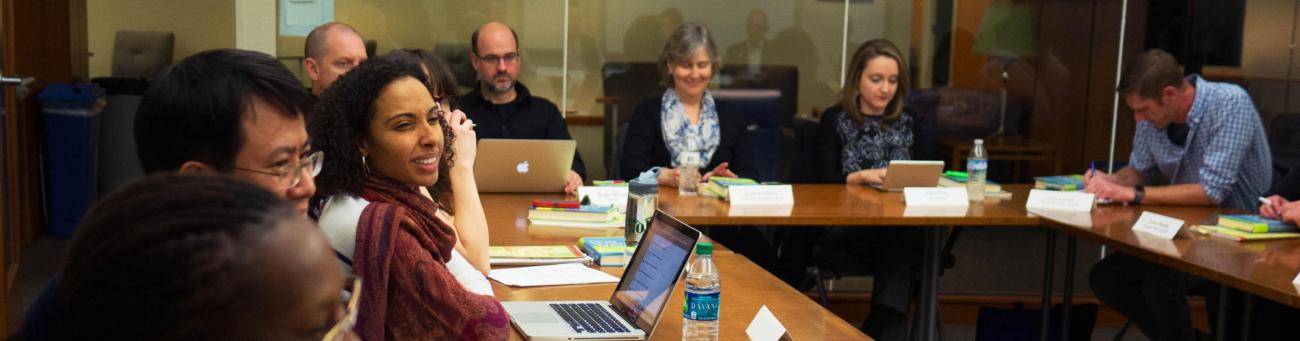 Members of the Bruning Teaching Academy engage in discussion during a meeting.
