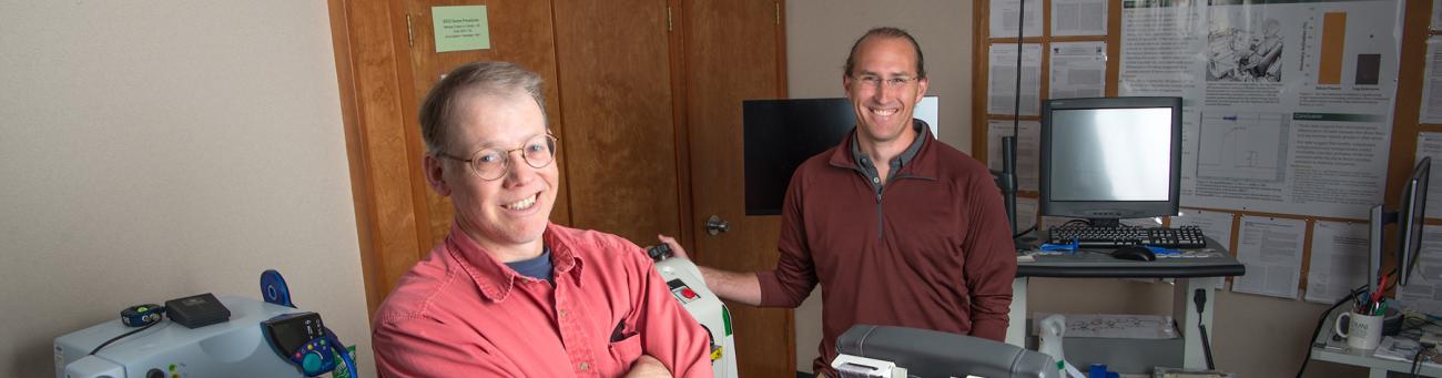 Professors pose in a lab