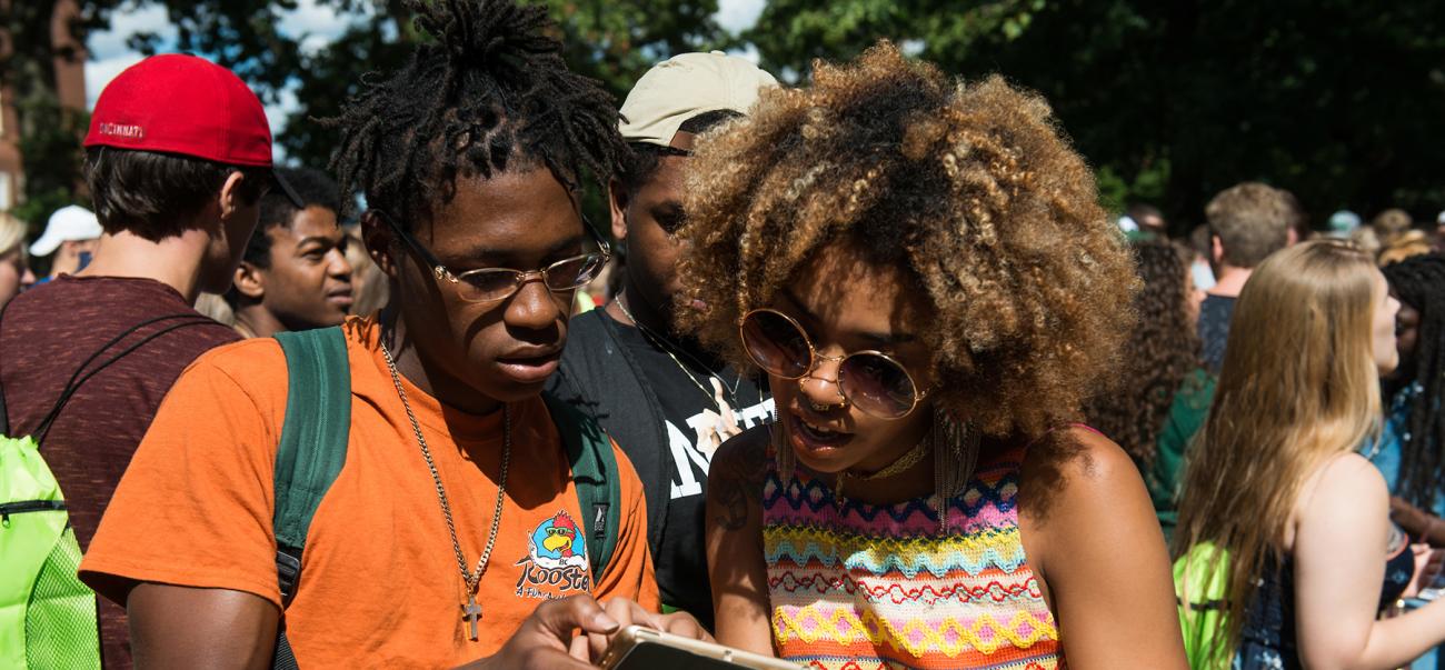 Two students look at a phone together