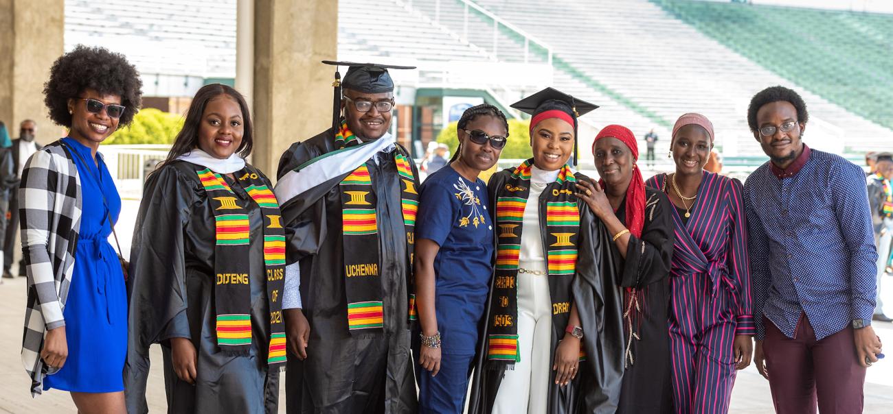 Graduate students and family pose for a photo after the Graduate Commencement Ceremony