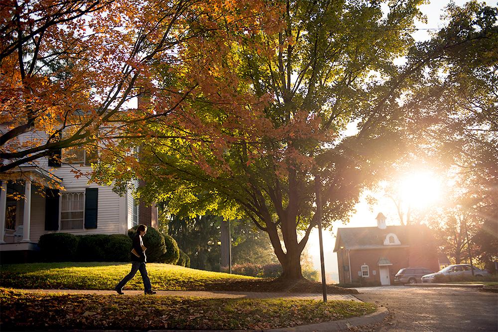Student walking on Ohio University Green