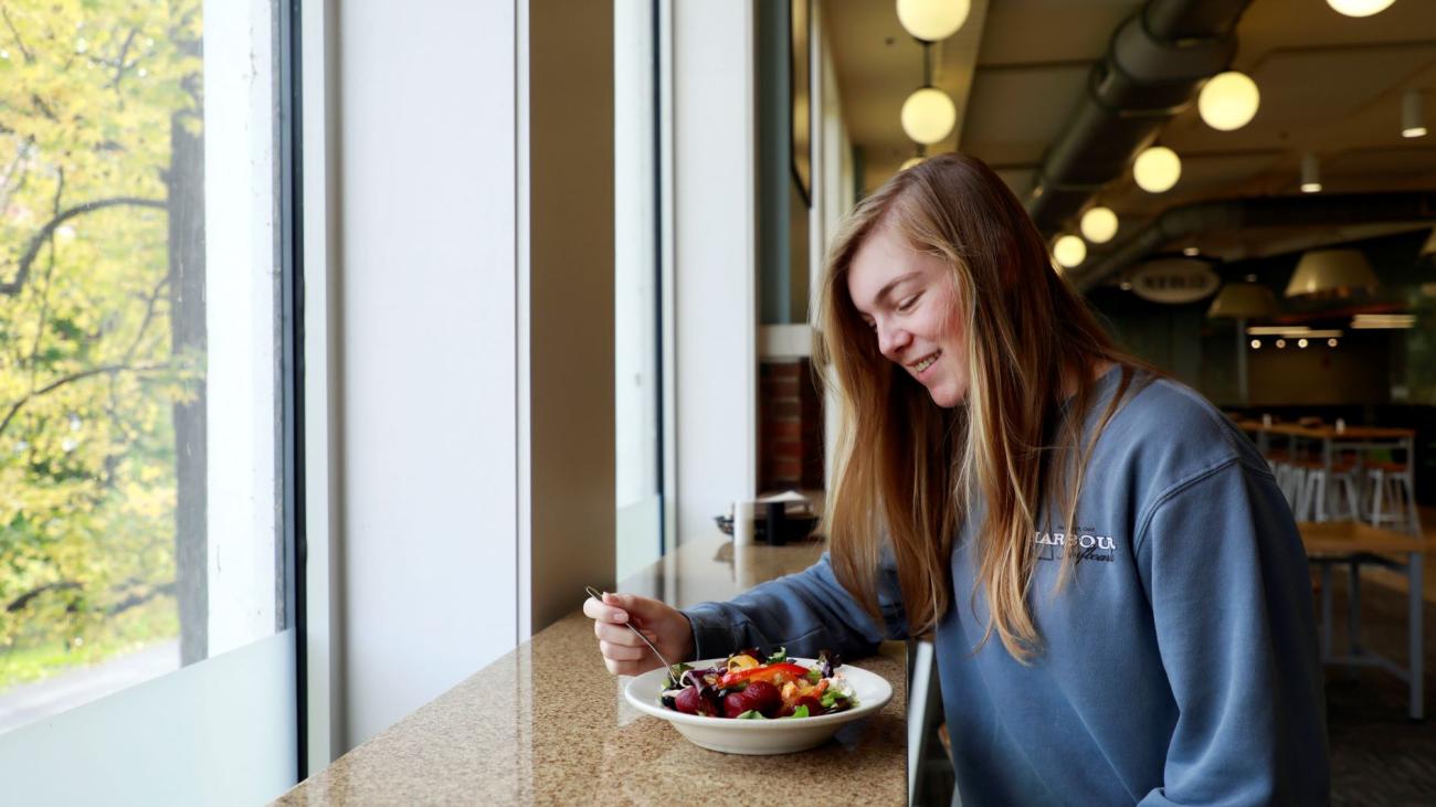 Student enjoying meal in dining court