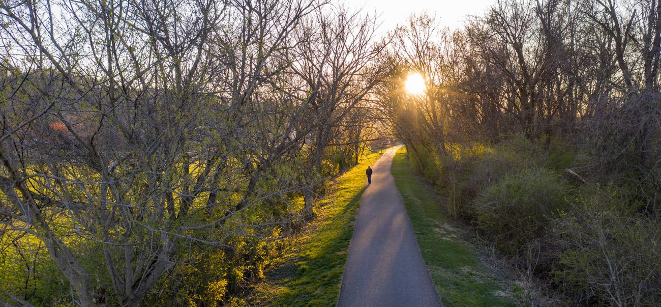 Someone walks on the bike path at sunset in Athens, Ohio