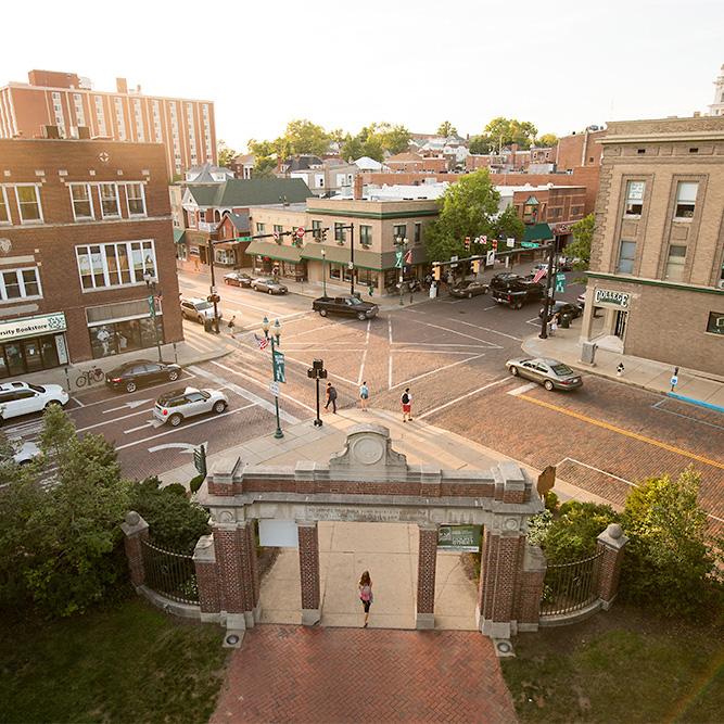 A student walks through class gateway toward Court Street.