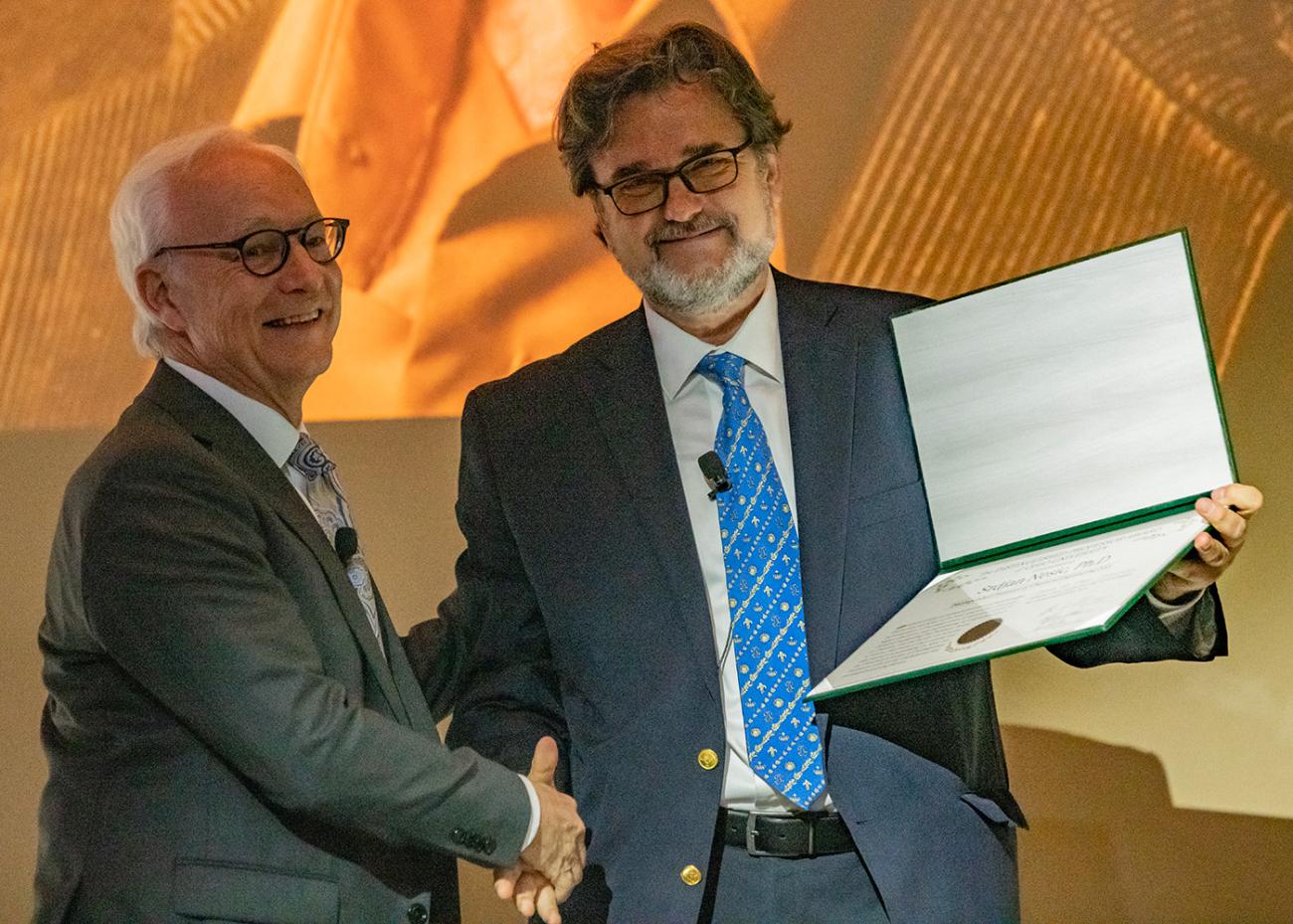 President Sherman presents an award to Srdjan Nesic.