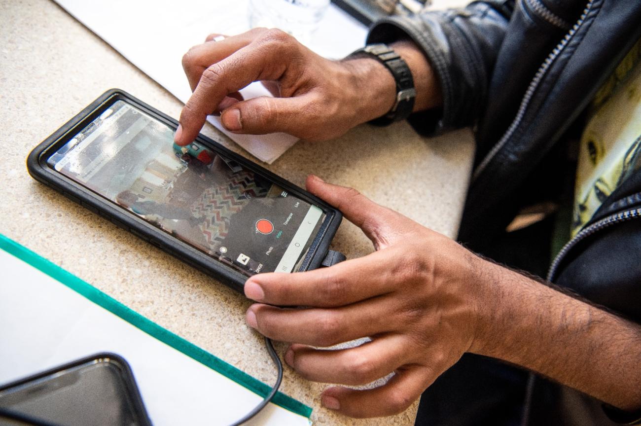 Person recording a video on cell phone. 