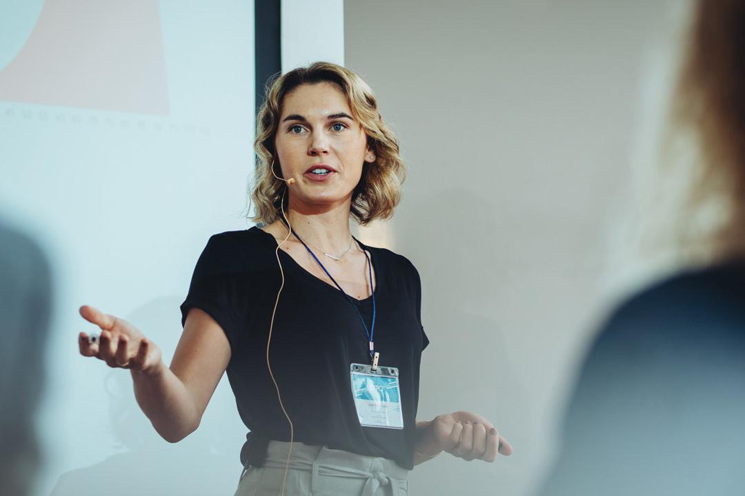 woman presenting to an audience